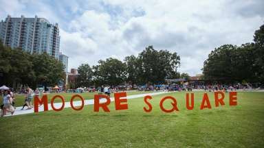 moore square spelled out in letters on the grass of the park